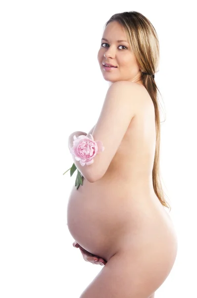 stock image Pregnant woman holding her belly and flower