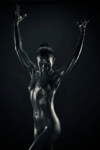 stock image Nude metallic woman holding