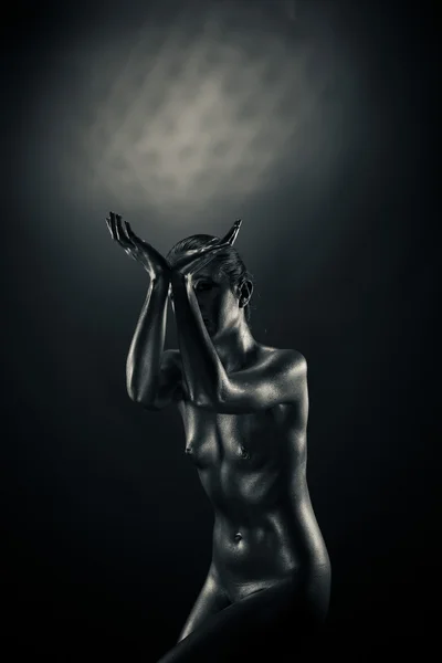 stock image Nude metallic woman holding