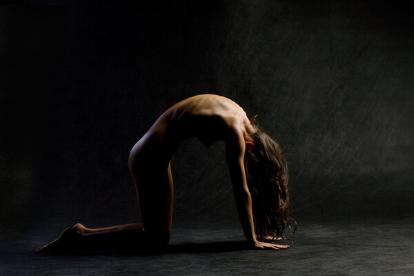 Naked woman in yoga pose