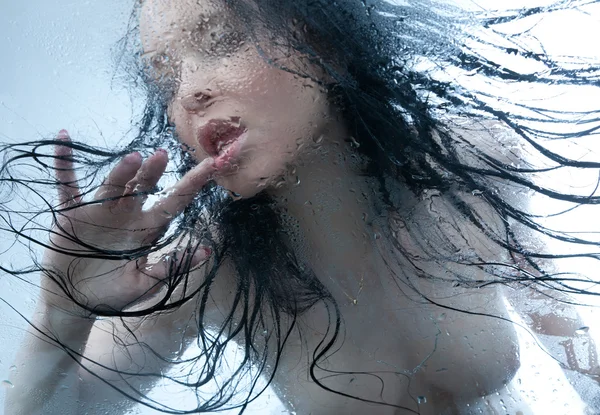 stock image Naked girl in a wet glass on a white background