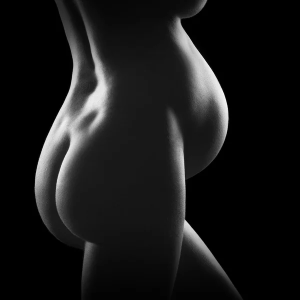 stock image Pregnant woman butts and belly, black background